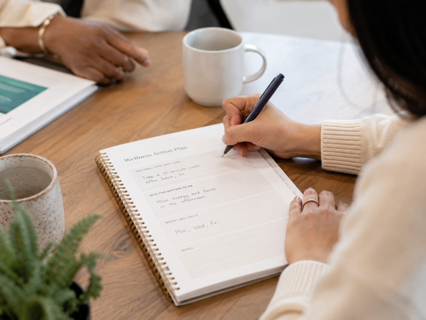 Employee writing practical steps in a Wellness Action Plan.